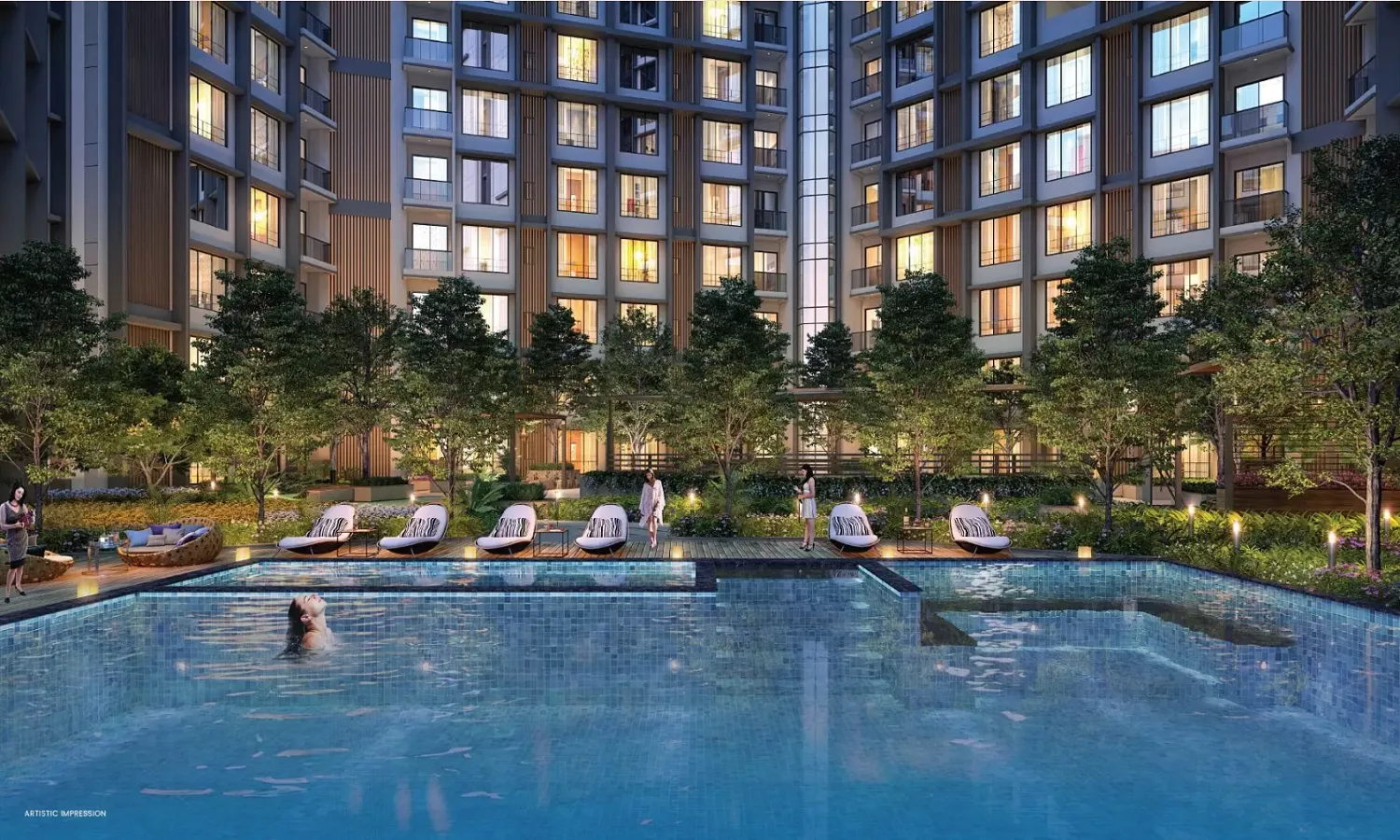 Evening view of the Purva Esplanade residential project in KIADB North Bangalore, featuring a large illuminated swimming pool, poolside loungers, landscaped greenery, and modern high-rise apartment towers in the background